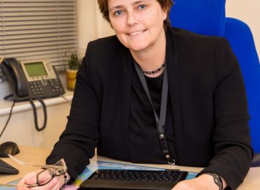 Deputy PFCC Jane Gardner sitting at her desk.